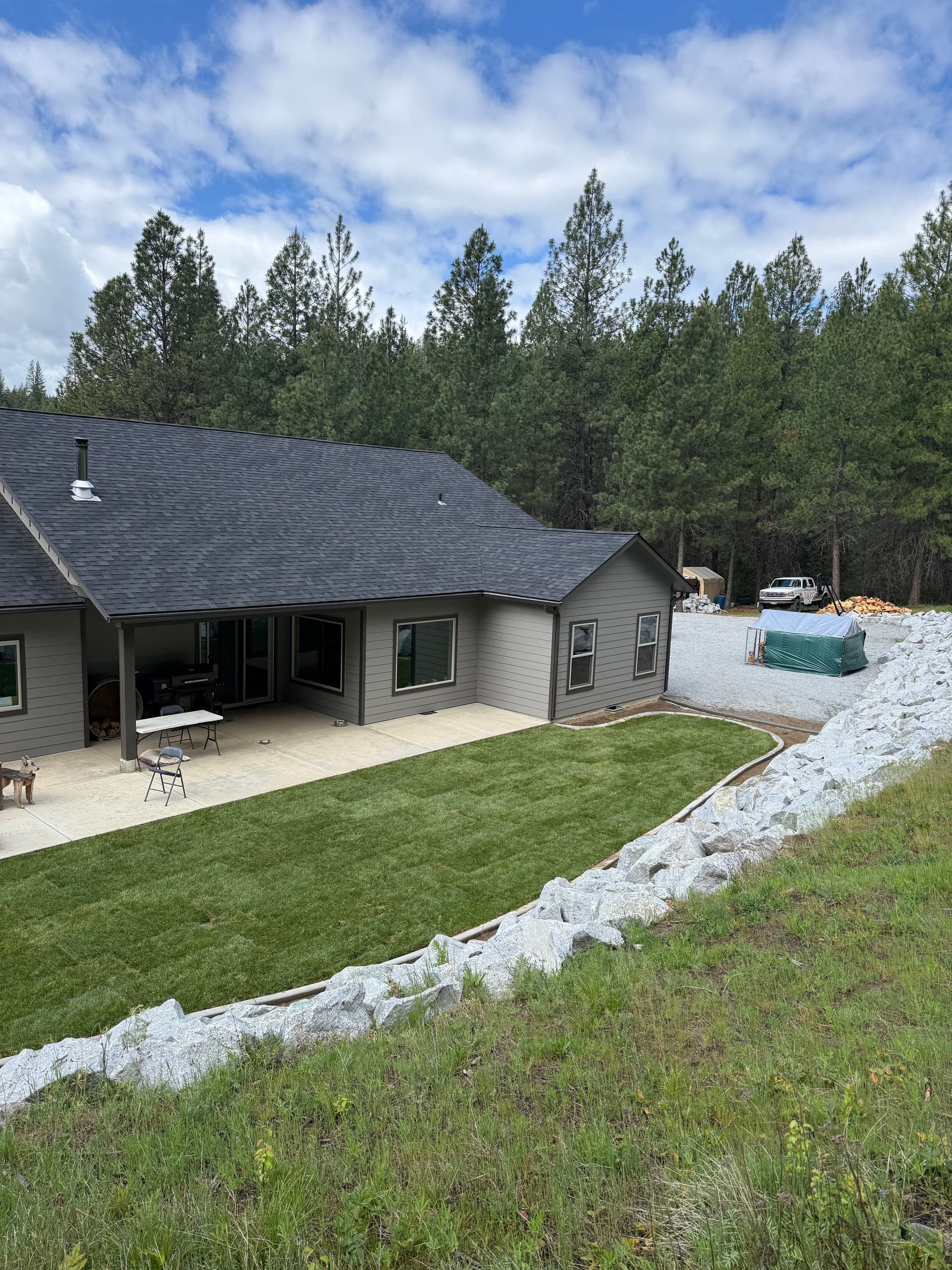 Fresh Sod and Boulder Walls Give This Yard a Clean Finished Look image