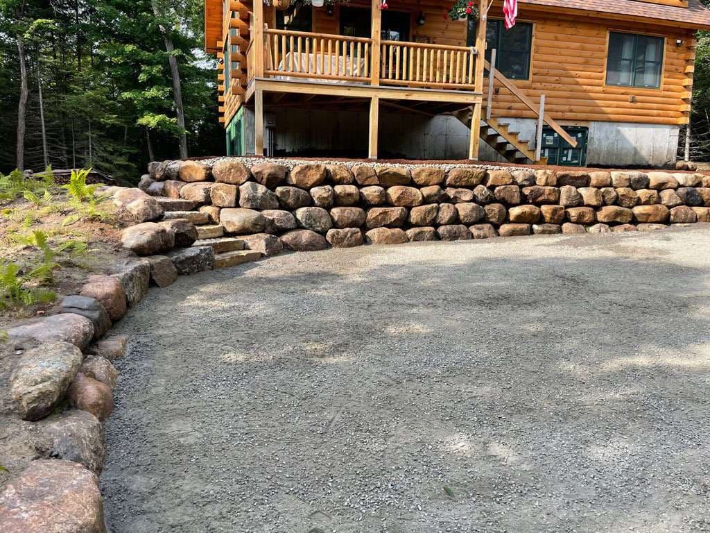 Log Home Enhanced with Sturdy Boulder Walls
