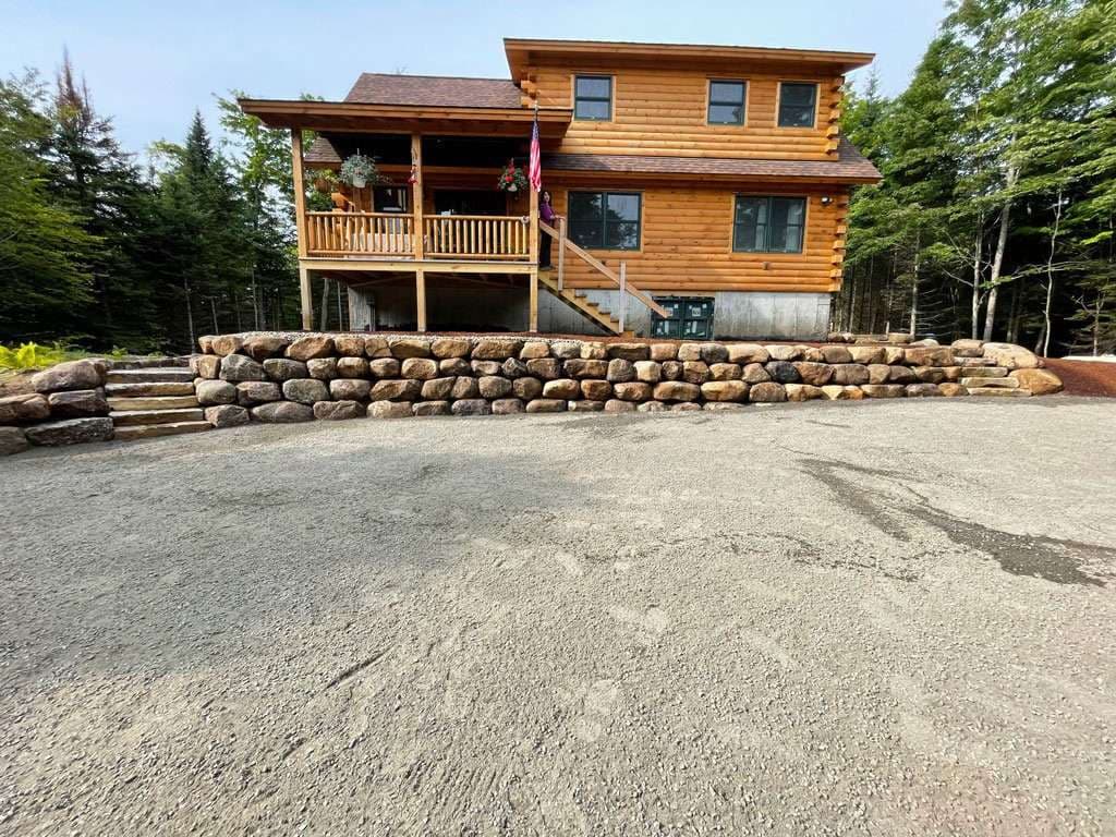 Project Log Home Enhanced with Sturdy Boulder Walls image