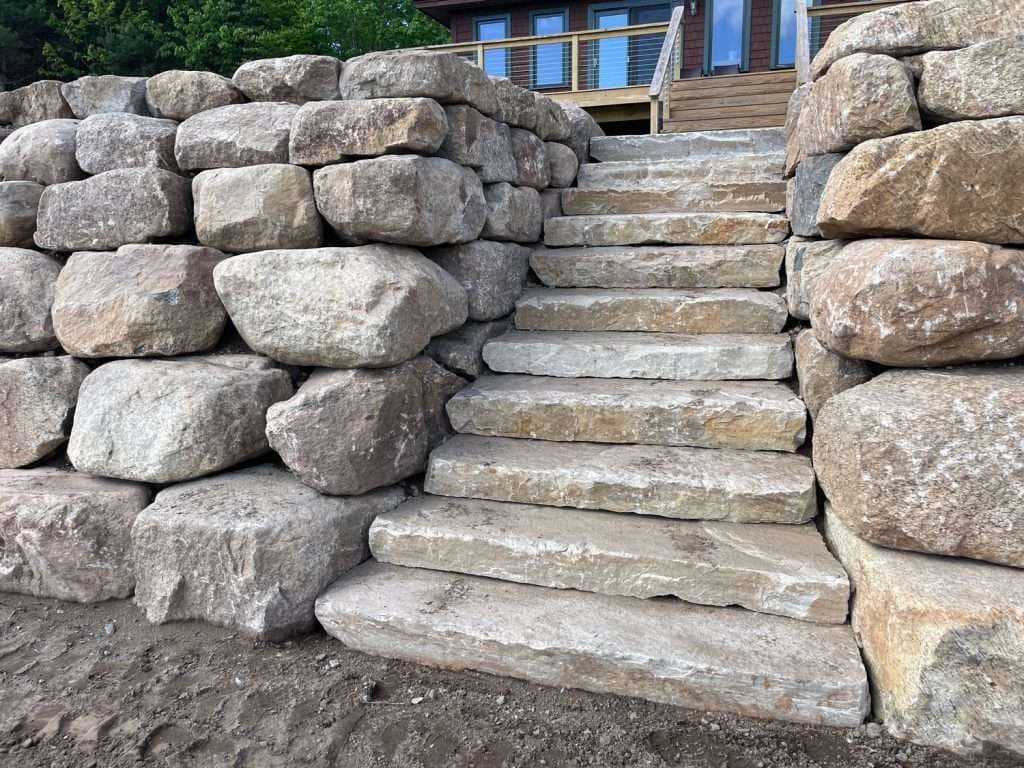 Enhancing Outdoor Spaces with Boulder Walls and Concrete Curbing image
